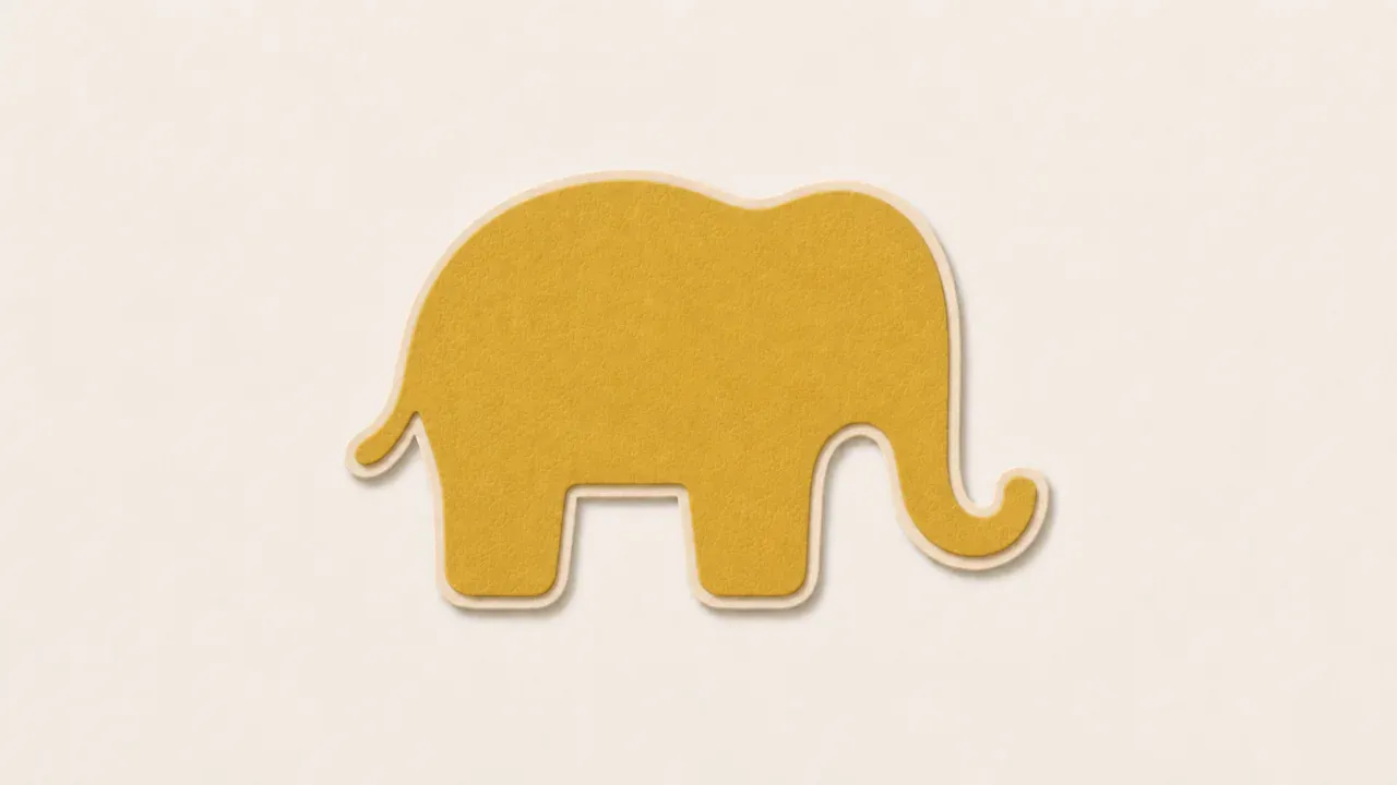A yellow paper elephant on a pale paper background