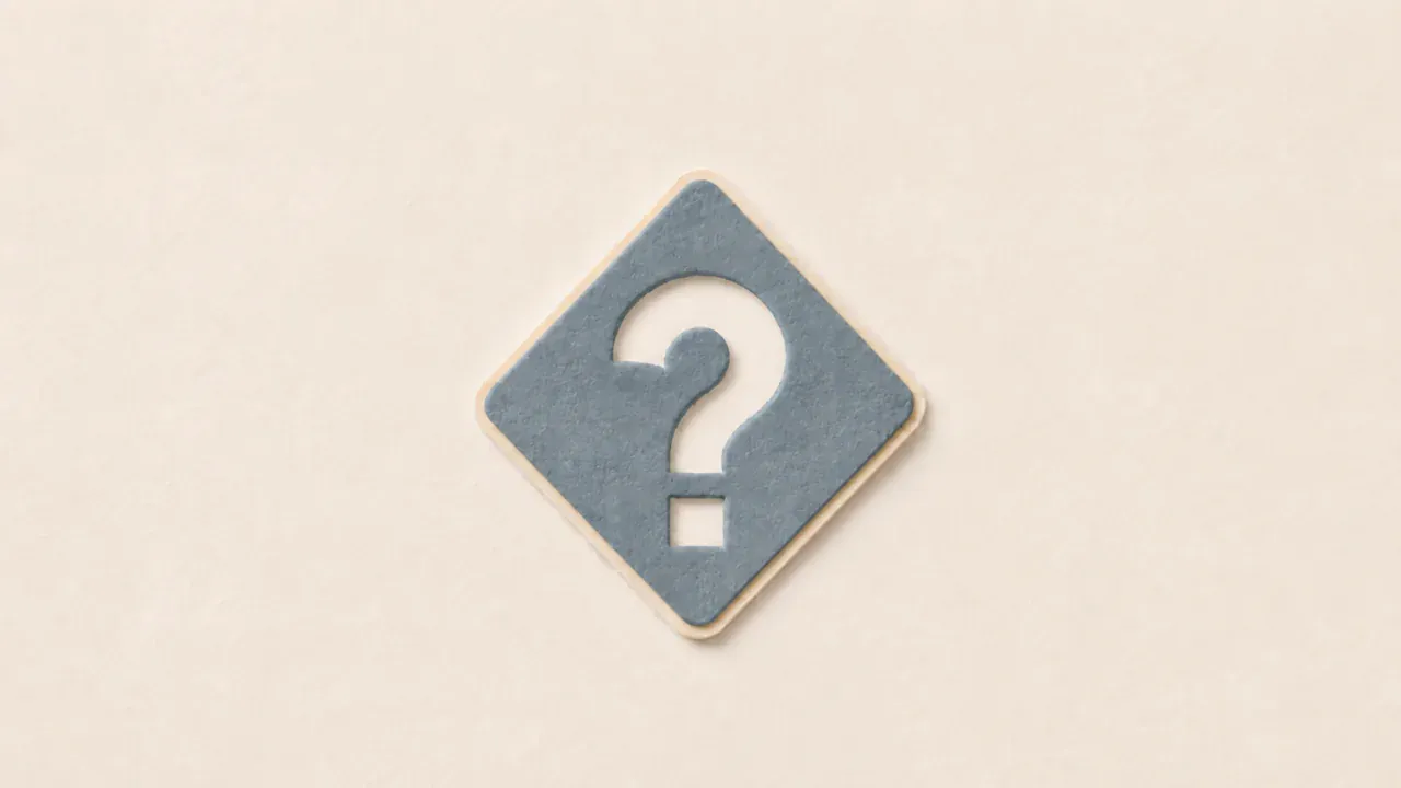 A slate paper diamond with a question mark cut out of it on a cream background